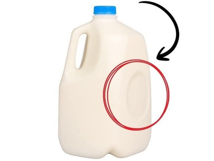Purpose of the Circular Dent on Milk Jugs