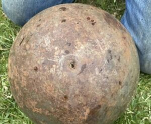 Found a giant ~150 lb. steel ball in a creek near my house. It has tiny boreholes and leaked black liquid when we rolled it around. Any ideas?